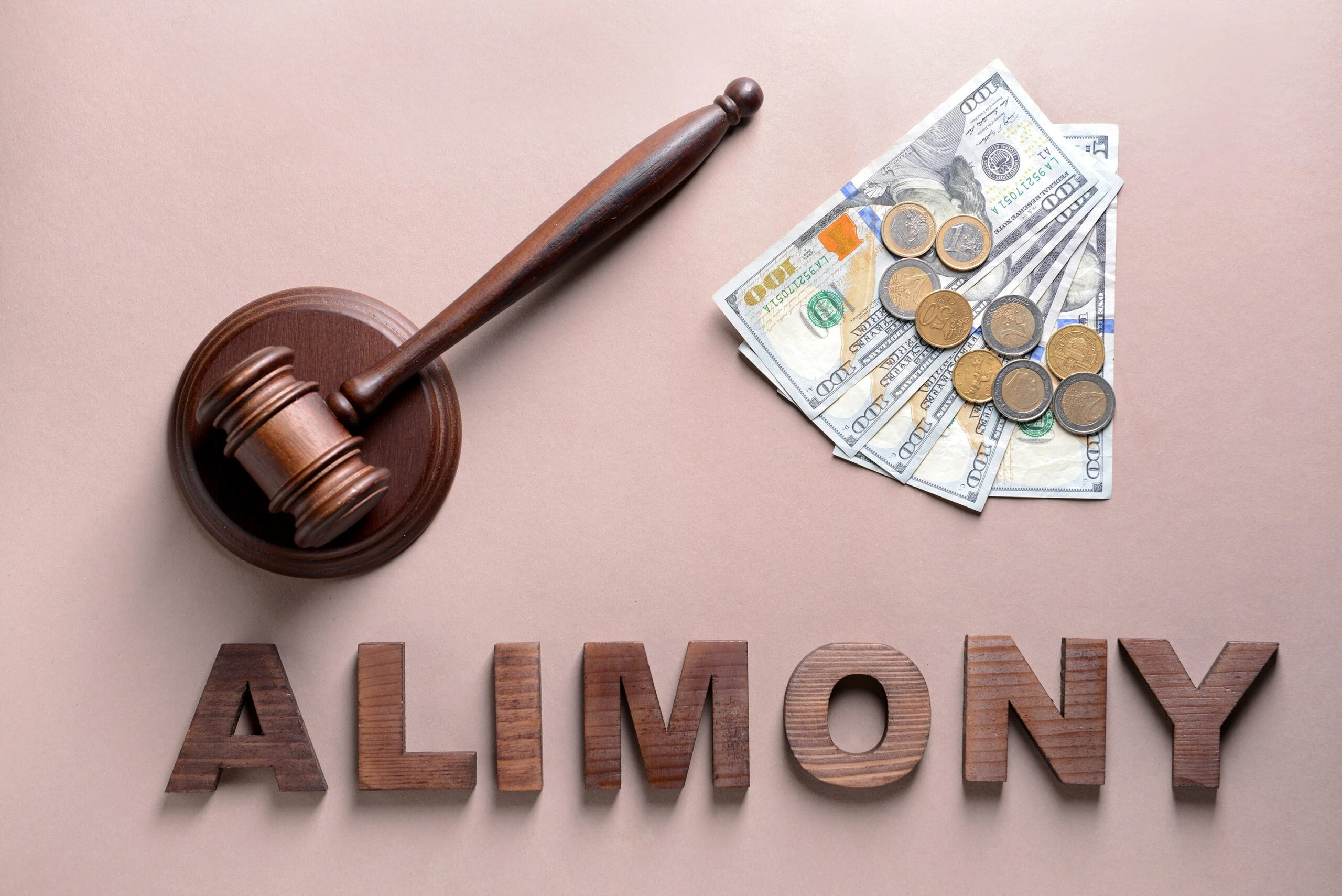 “Alimony” written in block letters with judge gavel and stack of money. A Houston alimony attorney can help you reach a fair alimony agreement.