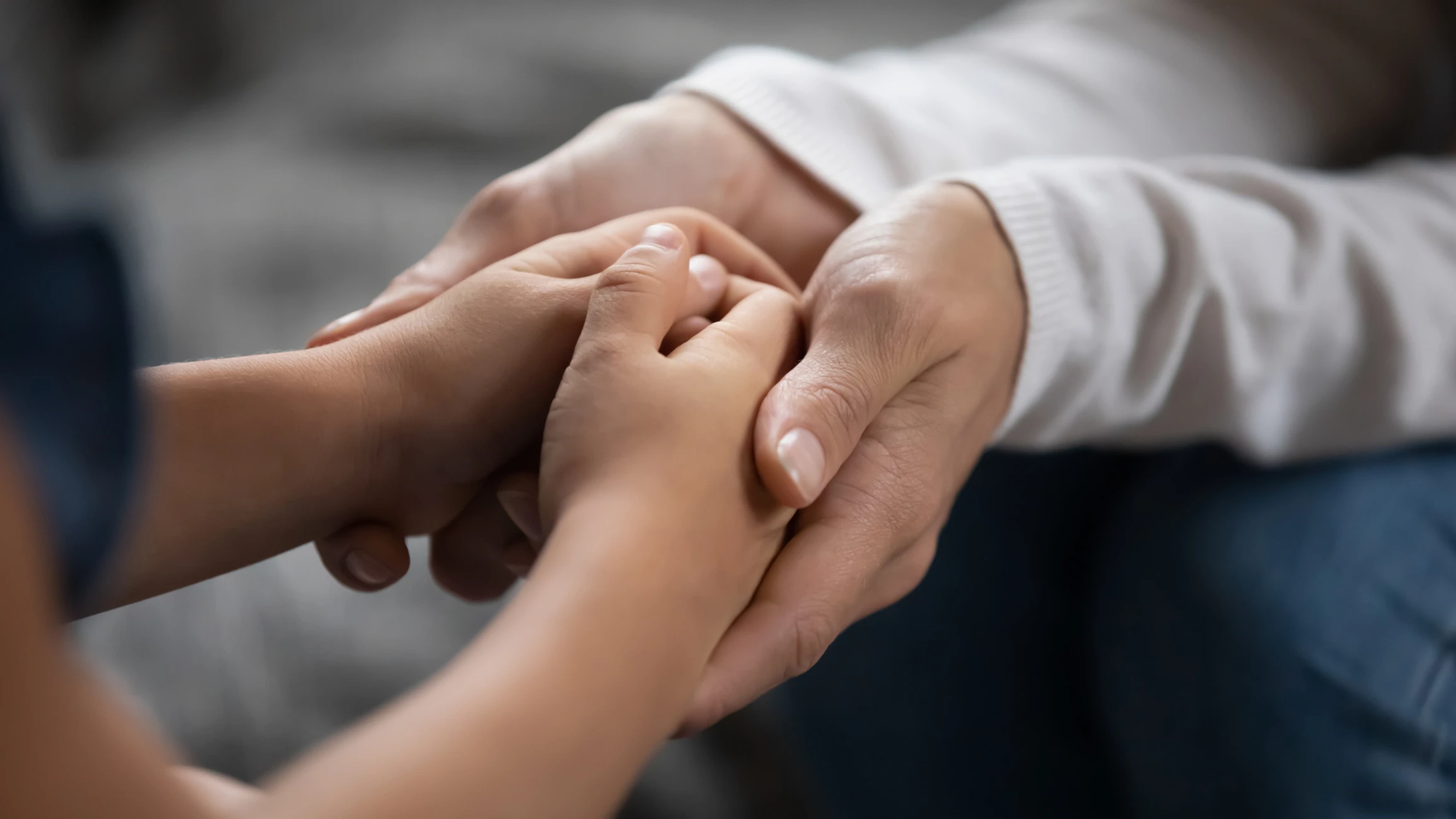 Close-up view of mother holding her child's hands. Our team of family law lawyers fight for those facing family law issues in Houston.