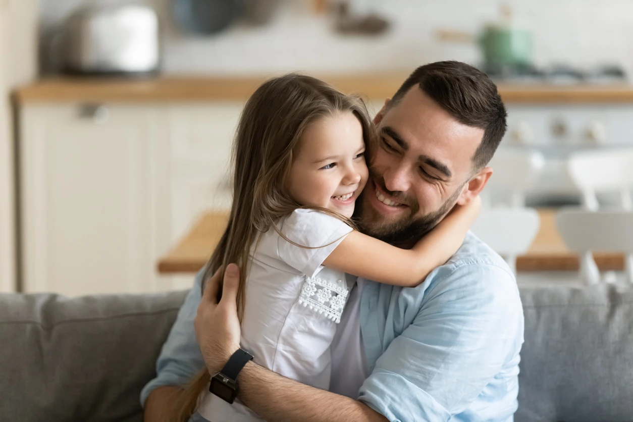 Young father hugging his small daughter. Our team of Houston divorce lawyers can help you reach a fair and favorable outcome in your child custody case. 