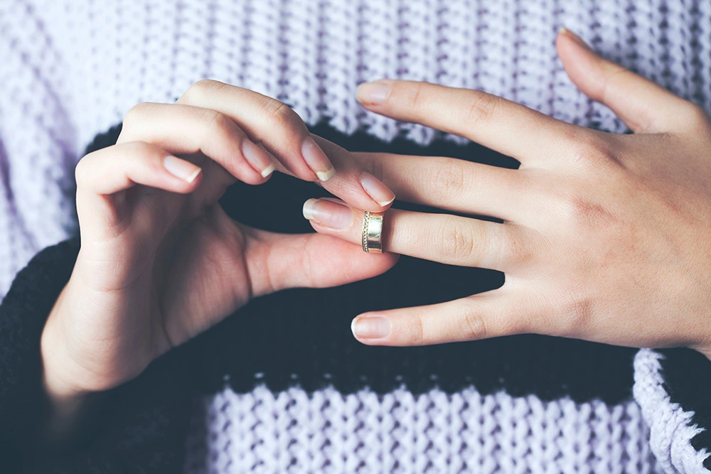 Close up view of woman removing wedding ring from her finger. If you live in Cypress, TX, and and are ready to separate from your spouse, our skilled divorce lawyers can help.