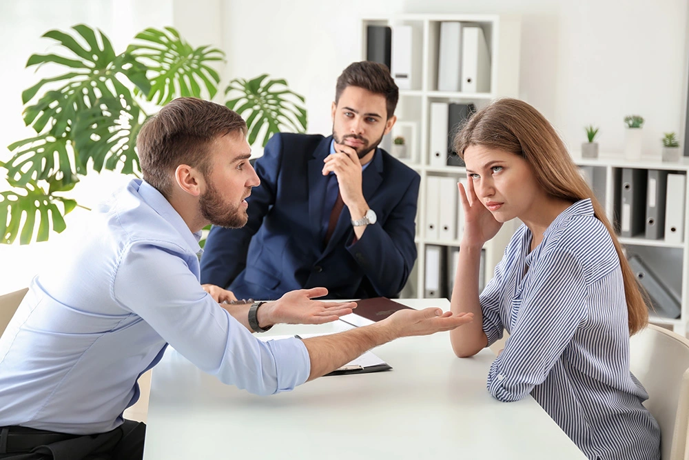 Couple arguing in front of a lawyer. For the fiercest representation in your family law case, contact us now.