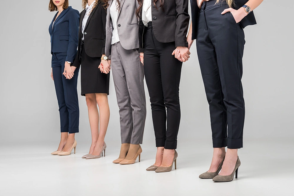 women wearing business casual clothes locking hands. Our Sugar Land women's rights lawyers take pride in protecting women's rights in divorce and other family law issues.