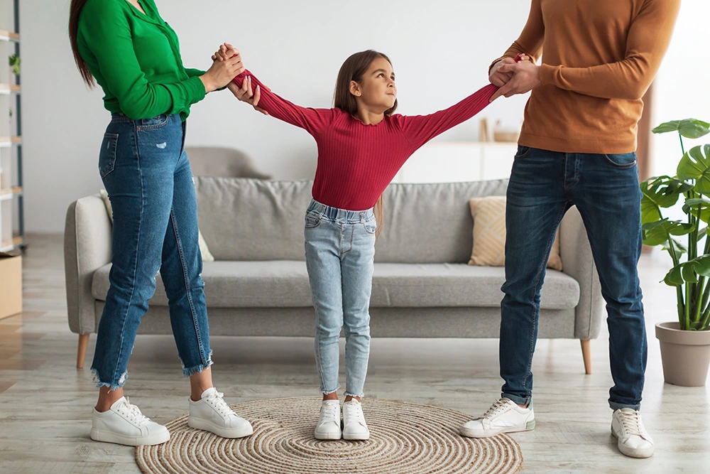 Mom and dad pulling daughter in different directions. If you need help modifying a custody order, our Sugar Land child custody lawyers can help.